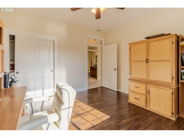 a living room with stainless steel appliances furniture and a kitchen view