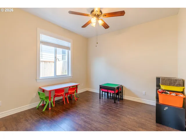 a view of a room with furniture and wooden floor