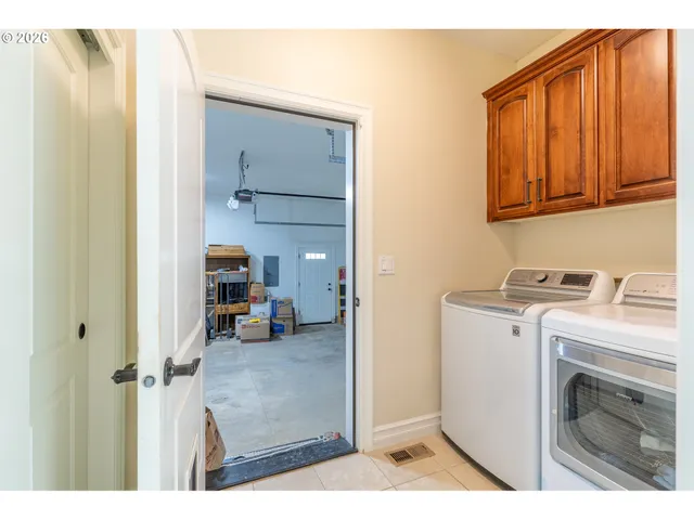 a view of storage and utility room with washer and dryer