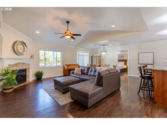 a living room with furniture a fireplace and wooden floor