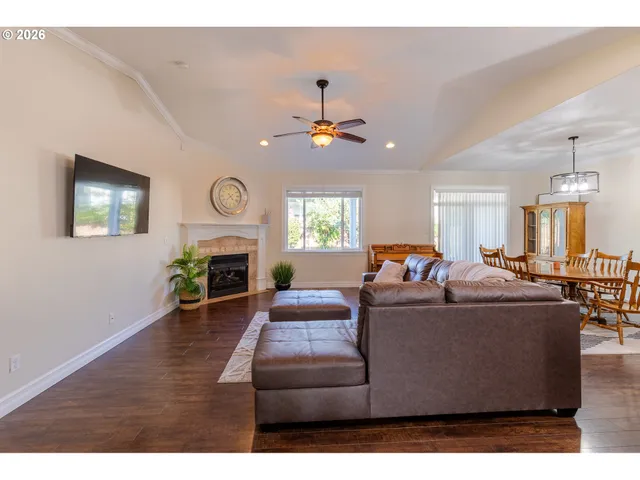 a living room with furniture a fireplace and a window