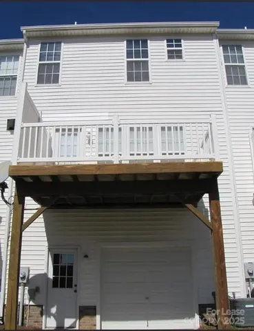 a balcony with a table and chairs