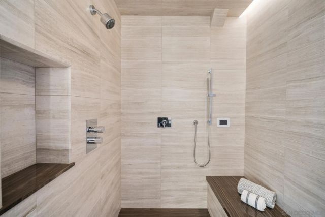 a large white room with a large window and chandelier