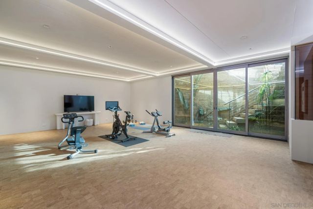 a bathroom with a glass shower door and a table