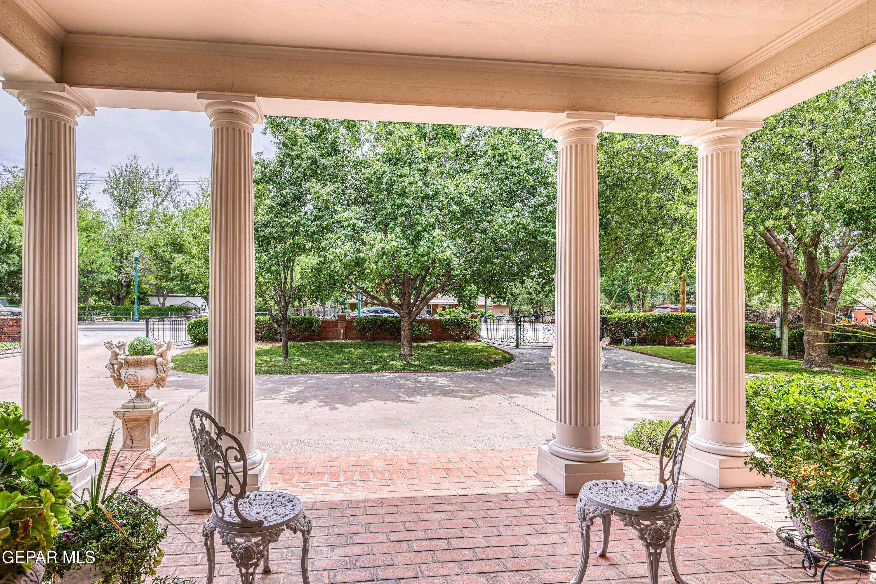 501 Country Club Road El Paso, TX 79932 - Photo 10 of 88 a view of a patio with table and chairs potted plants with floor to ceiling window