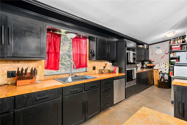 a kitchen with a sink cabinets and window