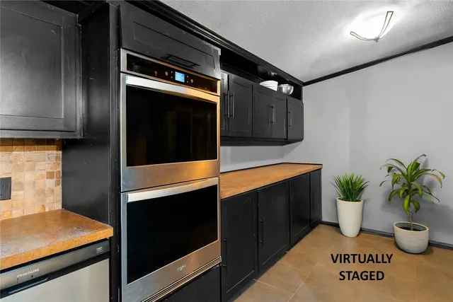 a kitchen with a sink and potted plant