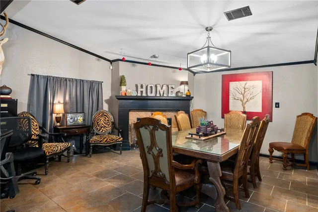 a dining room with furniture a chandelier and window