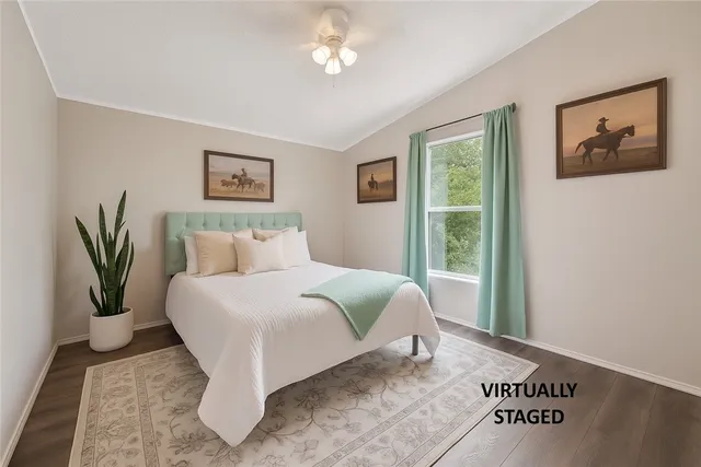 a bedroom with a bed and a painting on the wall