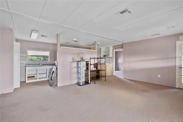 a view of a room with lots of wooden furniture