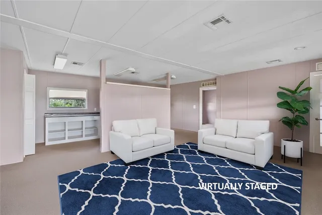 a living room with a couch and a rug