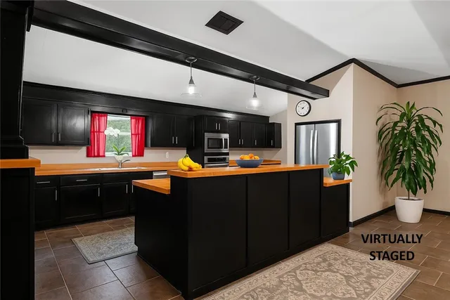 a kitchen with stainless steel appliances granite countertop a sink counter space and cabinets