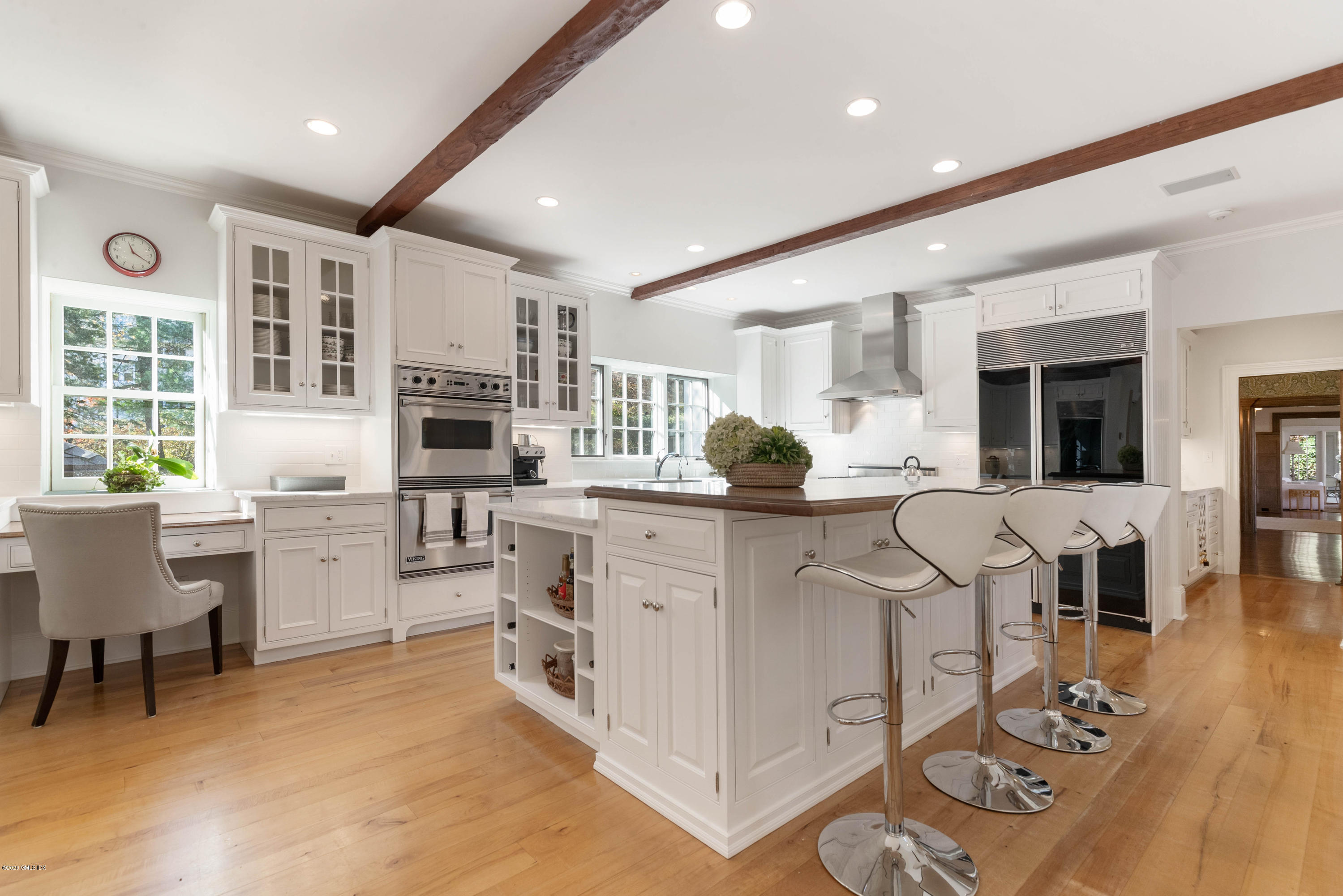7 Brookside Park Greenwich, CT 06831 - Photo 20 of 52 a kitchen with white cabinets and chairs
