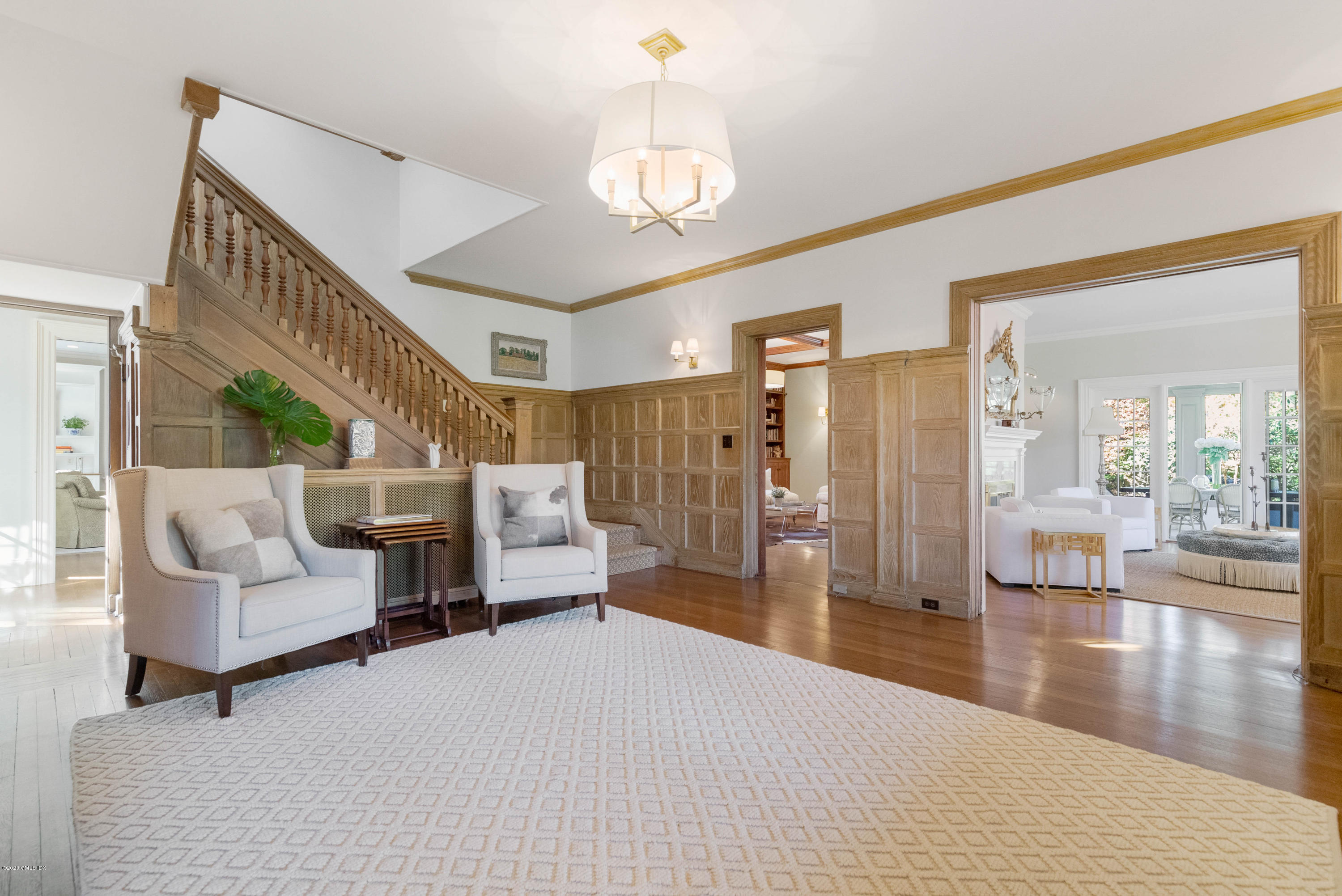 7 Brookside Park Greenwich, CT 06831 - Photo 10 of 52 a living room with furniture and a chandelier