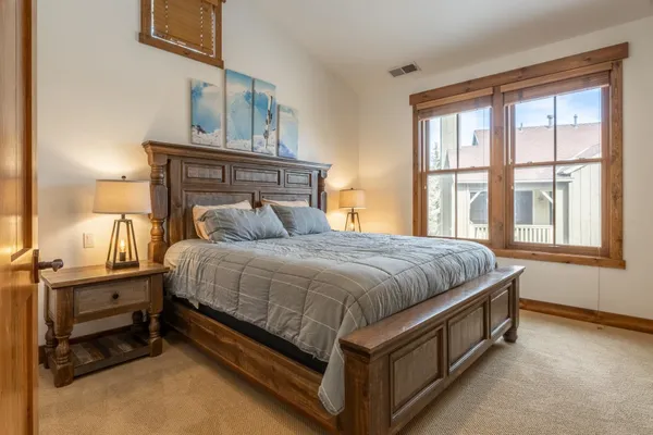 a bedroom with a bed and a television