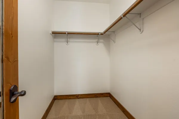 a bed sitting in a bedroom next to a window