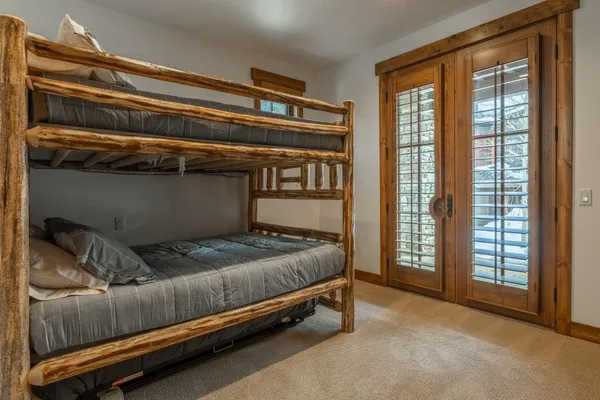 a bed sitting in a bedroom next to a window