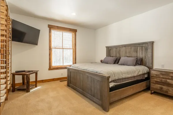 a bedroom with a bed and a window