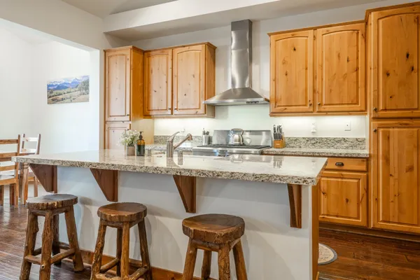 a kitchen with a sink stove and cabinets