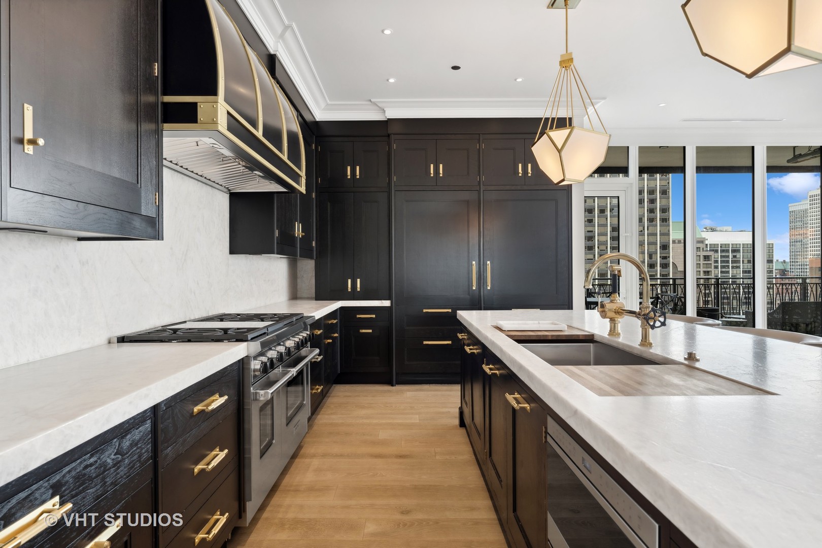9 West Walton Street, Unit 1901 Chicago, IL 60610 - Photo 12 of 64 a kitchen with stainless steel appliances granite countertop a sink a stove and a wooden floors