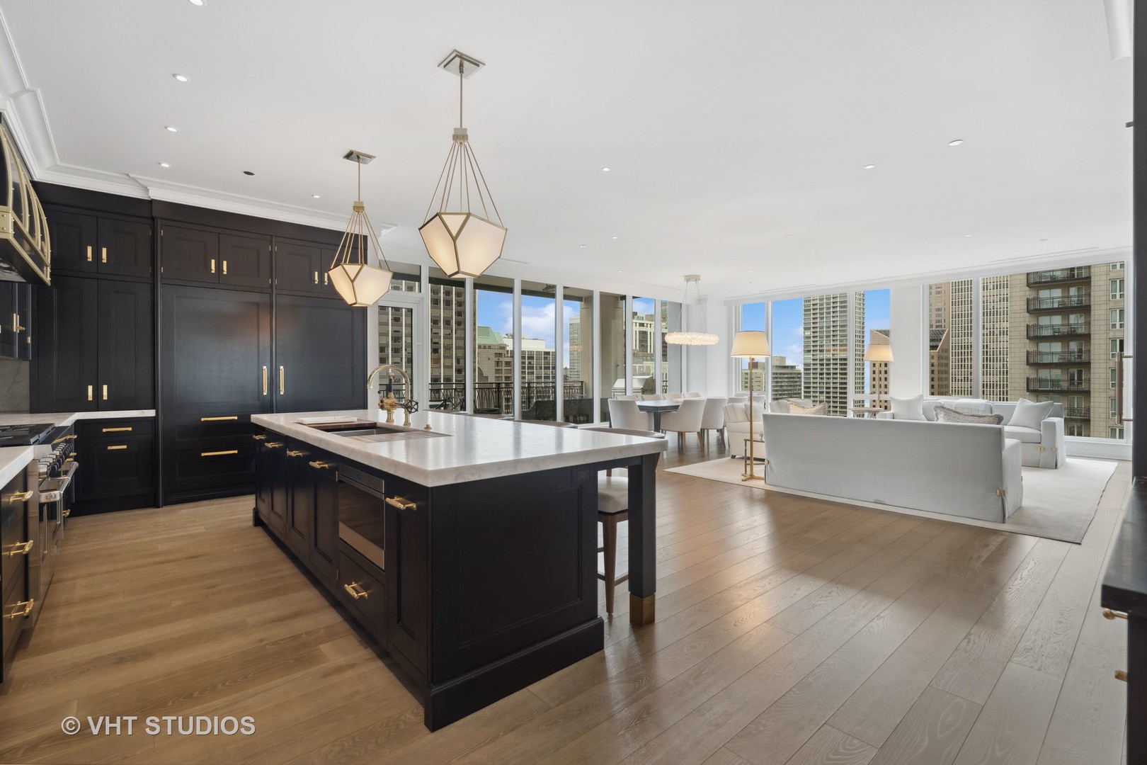 9 West Walton Street, Unit 1901 Chicago, IL 60610 - Photo 14 of 64 a kitchen with stainless steel appliances granite countertop a stove and a large kitchen island