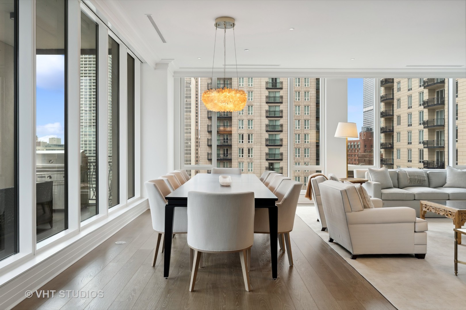 9 West Walton Street, Unit 1901 Chicago, IL 60610 - Photo 16 of 64 a view of a dining room with furniture windows and wooden floor