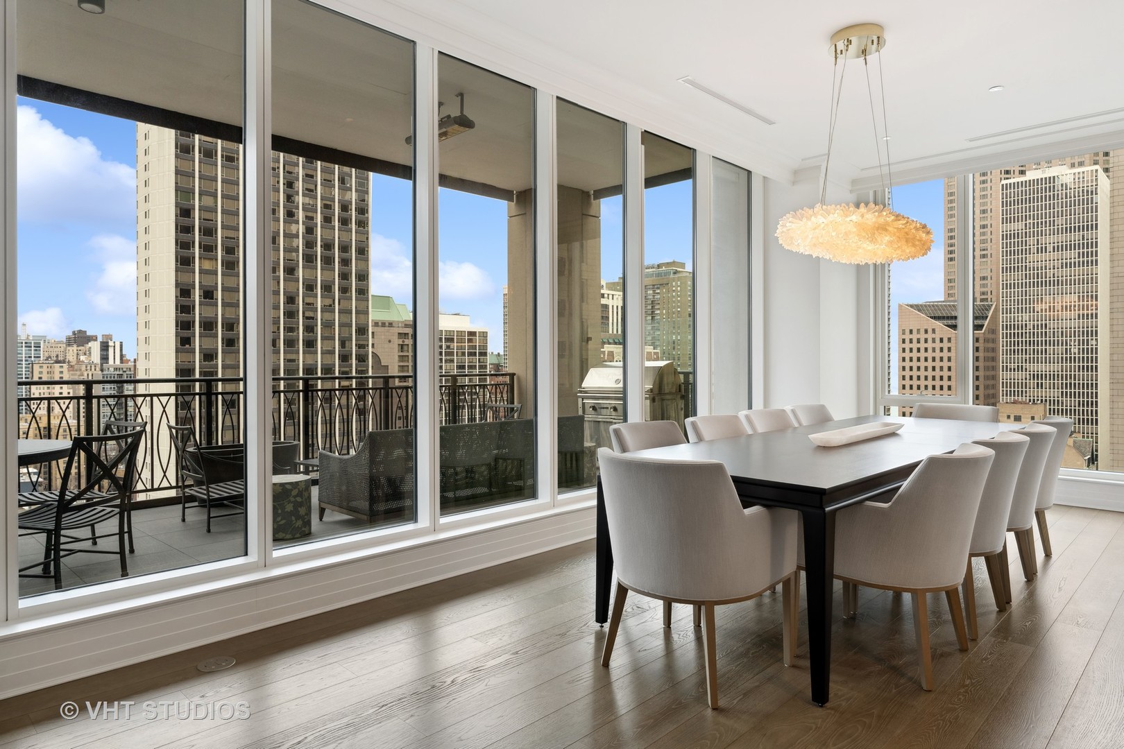 9 West Walton Street, Unit 1901 Chicago, IL 60610 - Photo 17 of 64 a dining room with furniture a chandelier and wooden floor