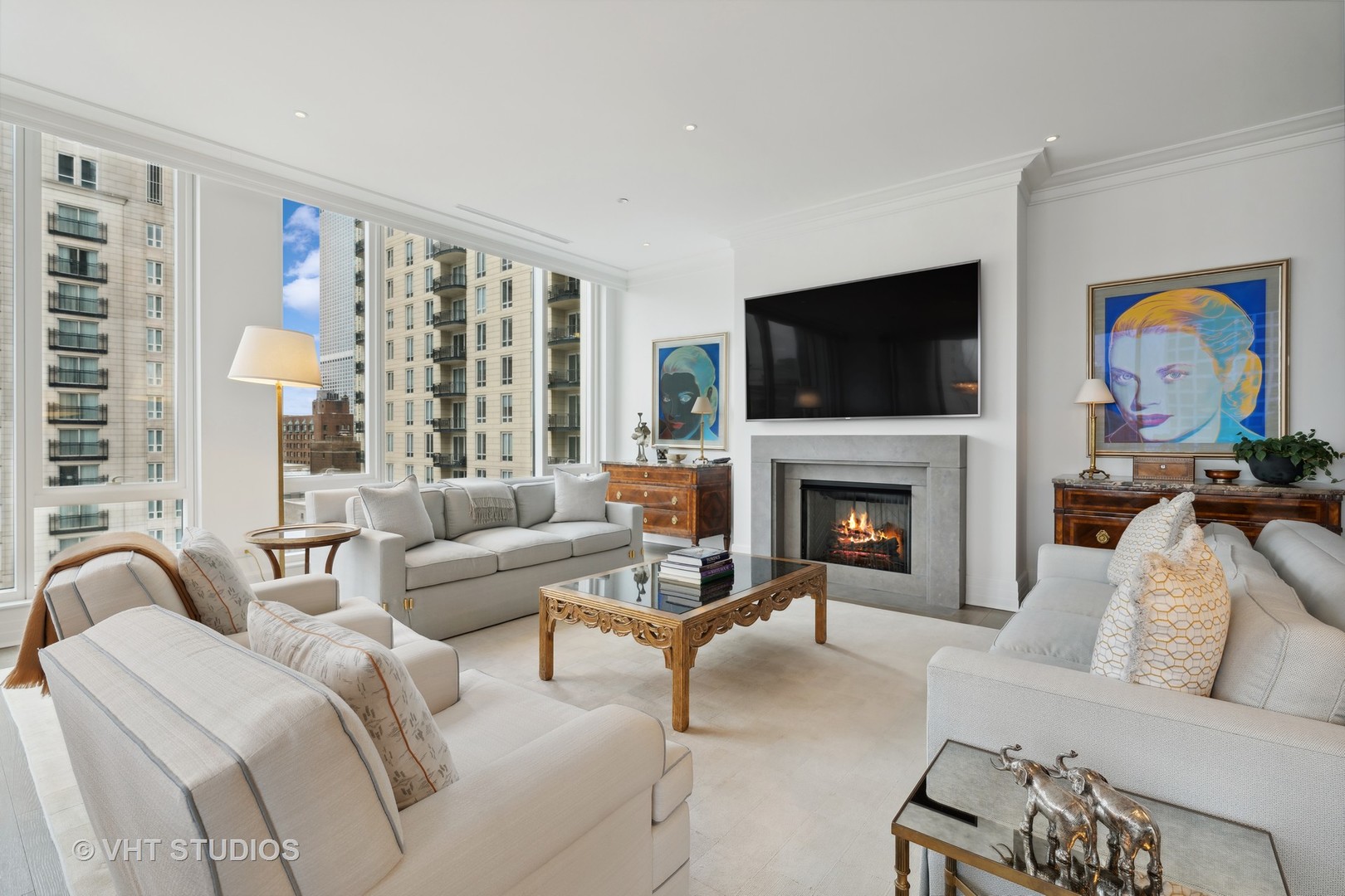 9 West Walton Street, Unit 1901 Chicago, IL 60610 - Photo 6 of 64 a living room with furniture a flat screen tv and a fireplace