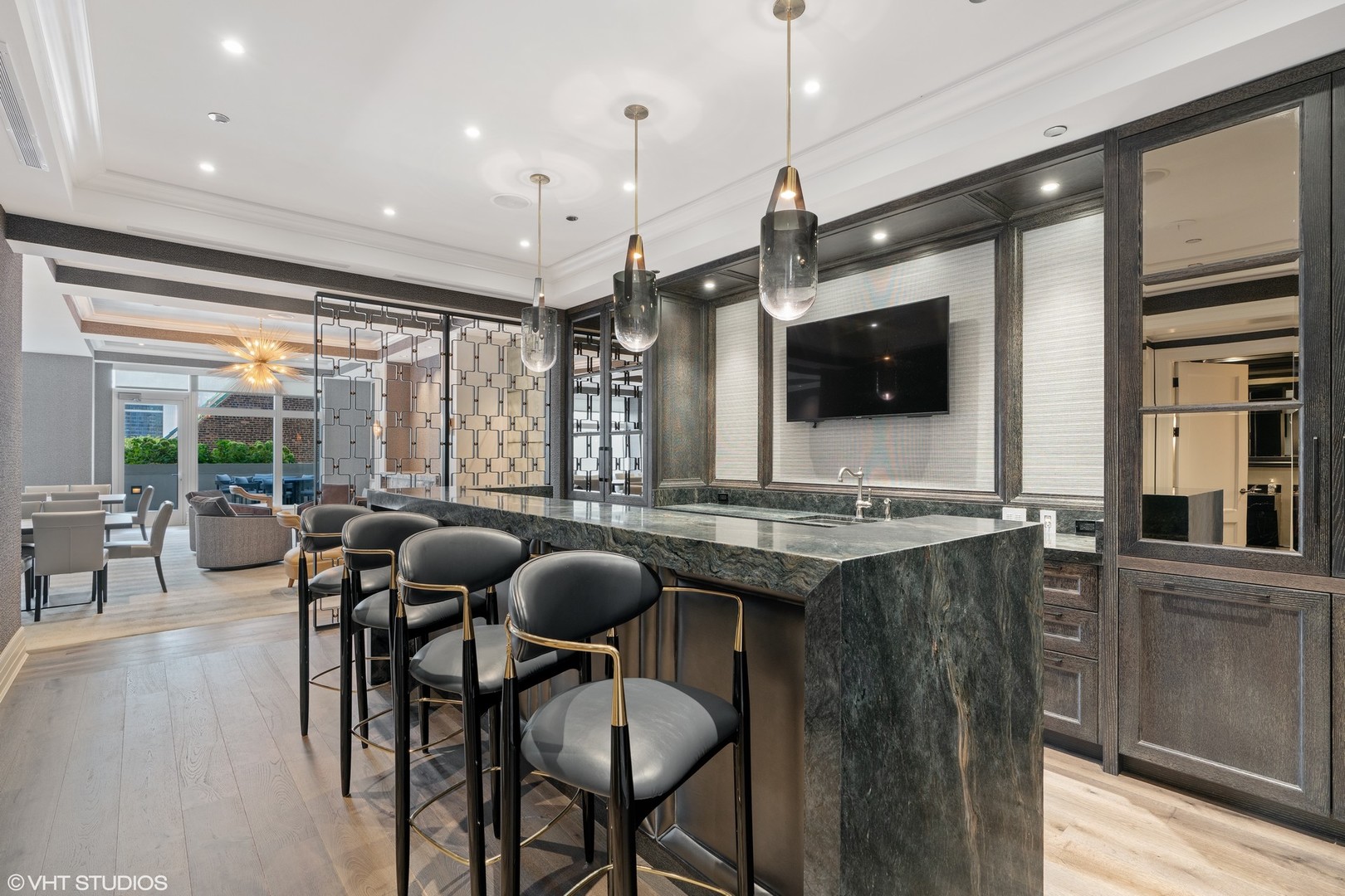9 West Walton Street, Unit 1901 Chicago, IL 60610 - Photo 62 of 64 a kitchen with stainless steel appliances granite countertop a table chairs and a refrigerator