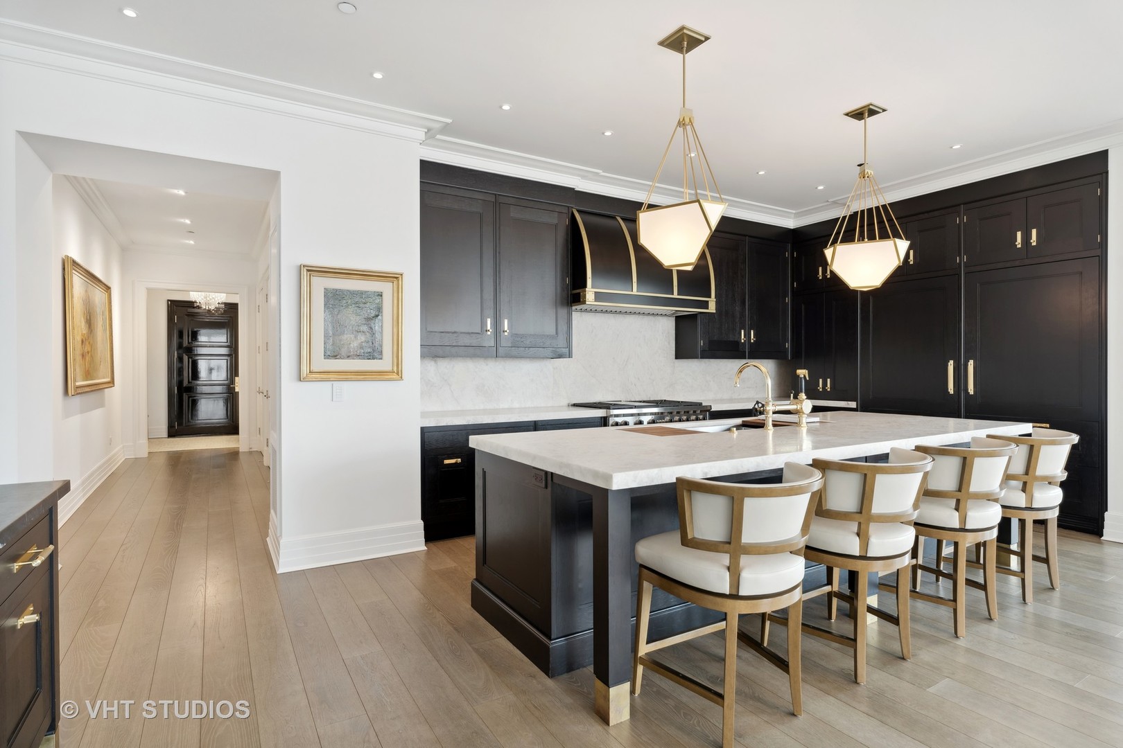 9 West Walton Street, Unit 1901 Chicago, IL 60610 - Photo 10 of 64 a kitchen with a table and chairs in it