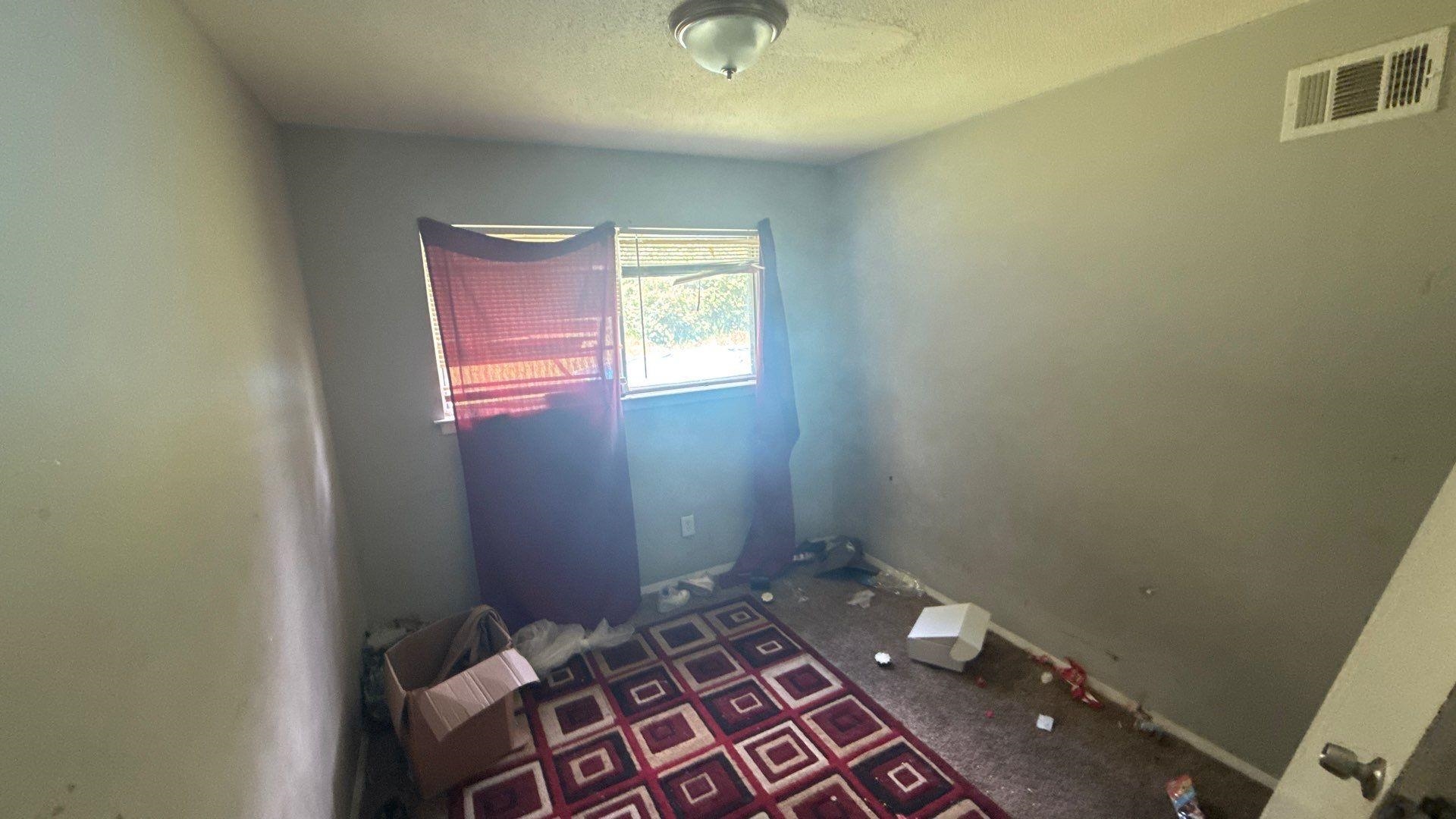 4939 Manson Road Memphis, TN 38109 - Photo 10 of 17 Room with light gray walls, a single window, and a ceiling-mounted light fixture