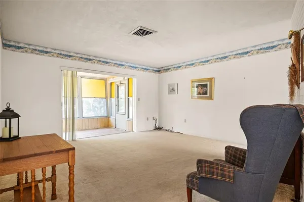 a spacious bedroom with a bed and chair