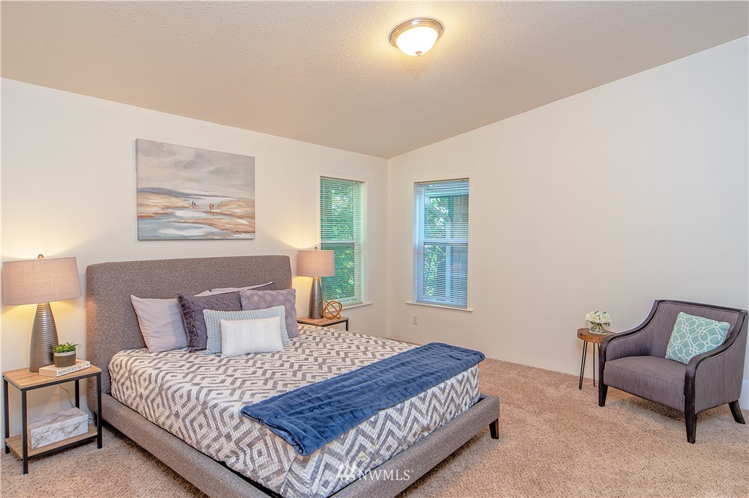 7054 Beaver Valley Road Port Hadlock, WA 98339 - Photo 22 of 40 a bedroom with bed and window