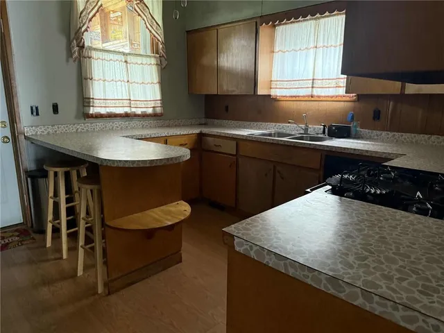 a kitchen with a stove a sink and a refrigerator
