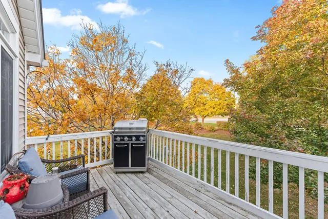 a view of a roof deck with couches and wooden floor