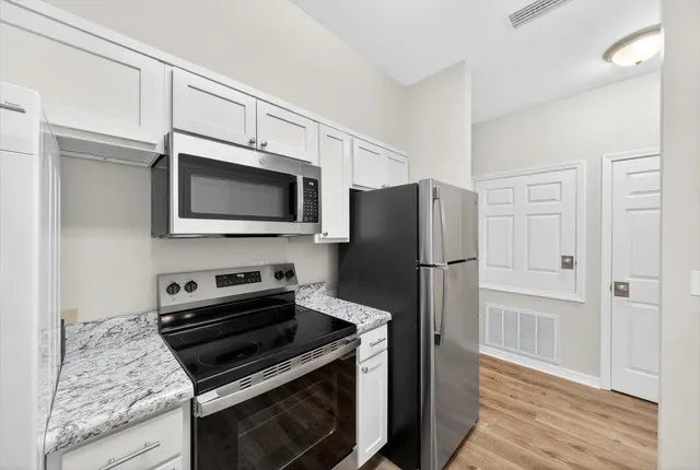 a kitchen with a stove microwave and refrigerator