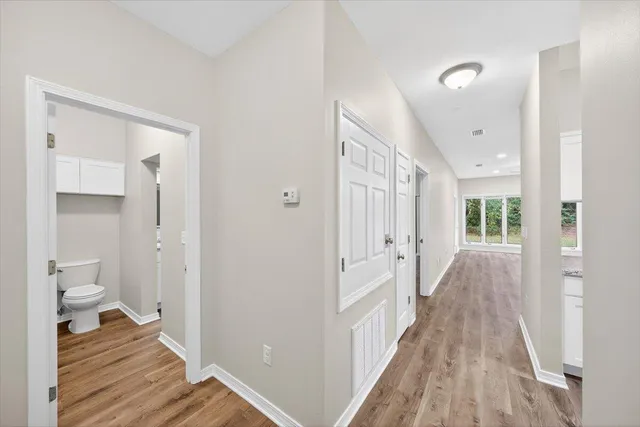 a view of a room with wooden floor and a toilet