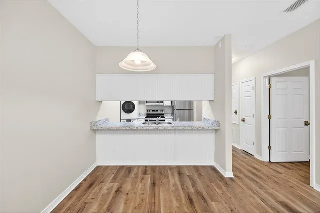 a view of kitchen with sink and microwave