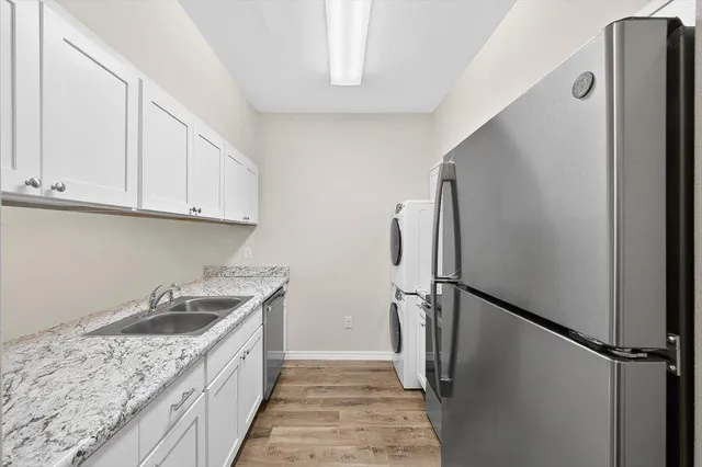 a kitchen with a sink and refrigerator