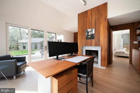 a view of a workspace with furniture and a window