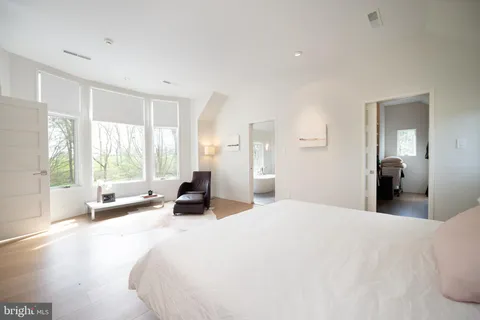 a bed sitting in a bedroom next to a window