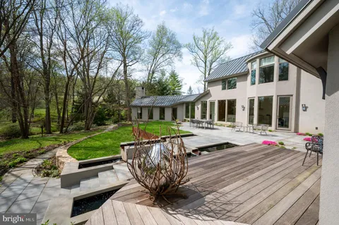 an aerial view of residential houses with outdoor space and trees