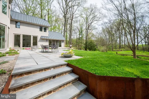 a view of a house with a yard and sitting area