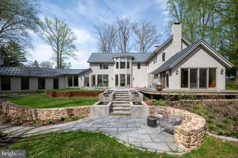 a backyard of a house with a yard and outdoor seating