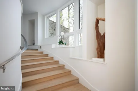 a living room with furniture fireplace and window