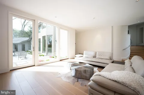 a living room with a table chairs and a flat screen tv