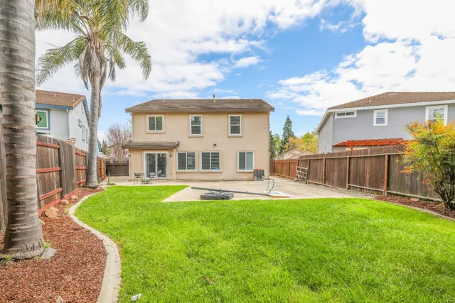 a view of a house with a yard and sitting area
