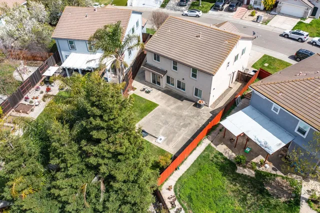 an aerial view of a house with a yard and deck