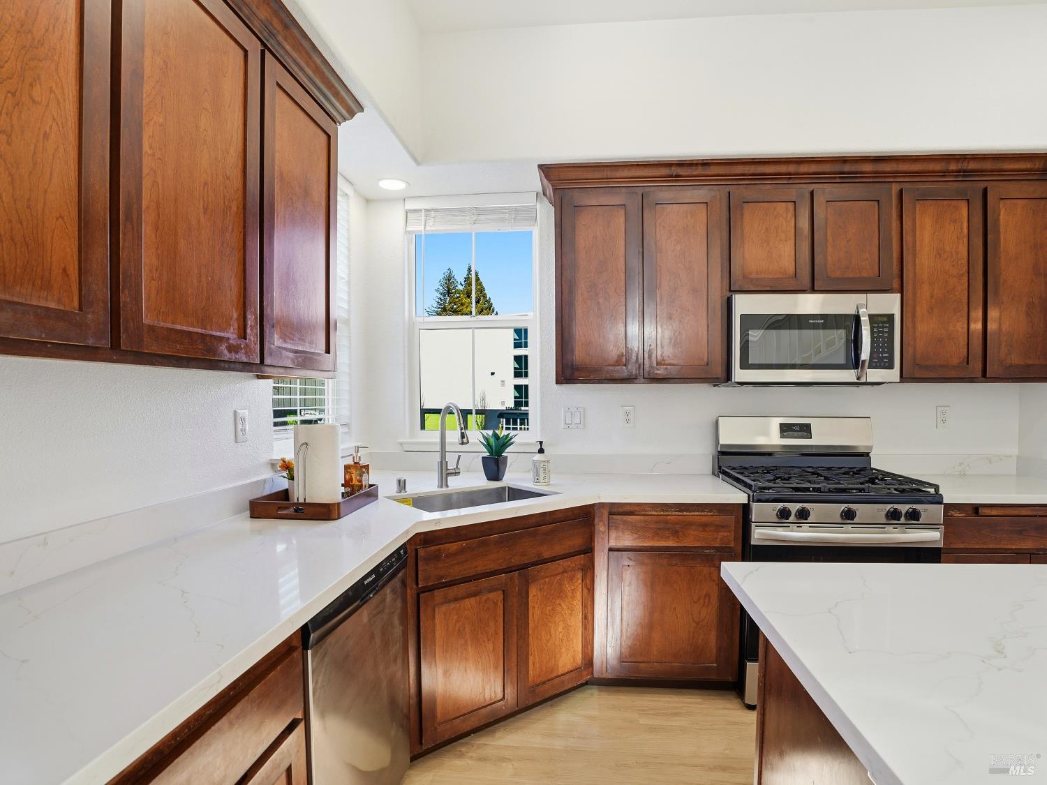 4424 Streamside Drive Santa Rosa, CA 95409 - Photo 14 of 55 a kitchen with stainless steel appliances granite countertop wooden cabinets a stove top oven a sink and dishwasher