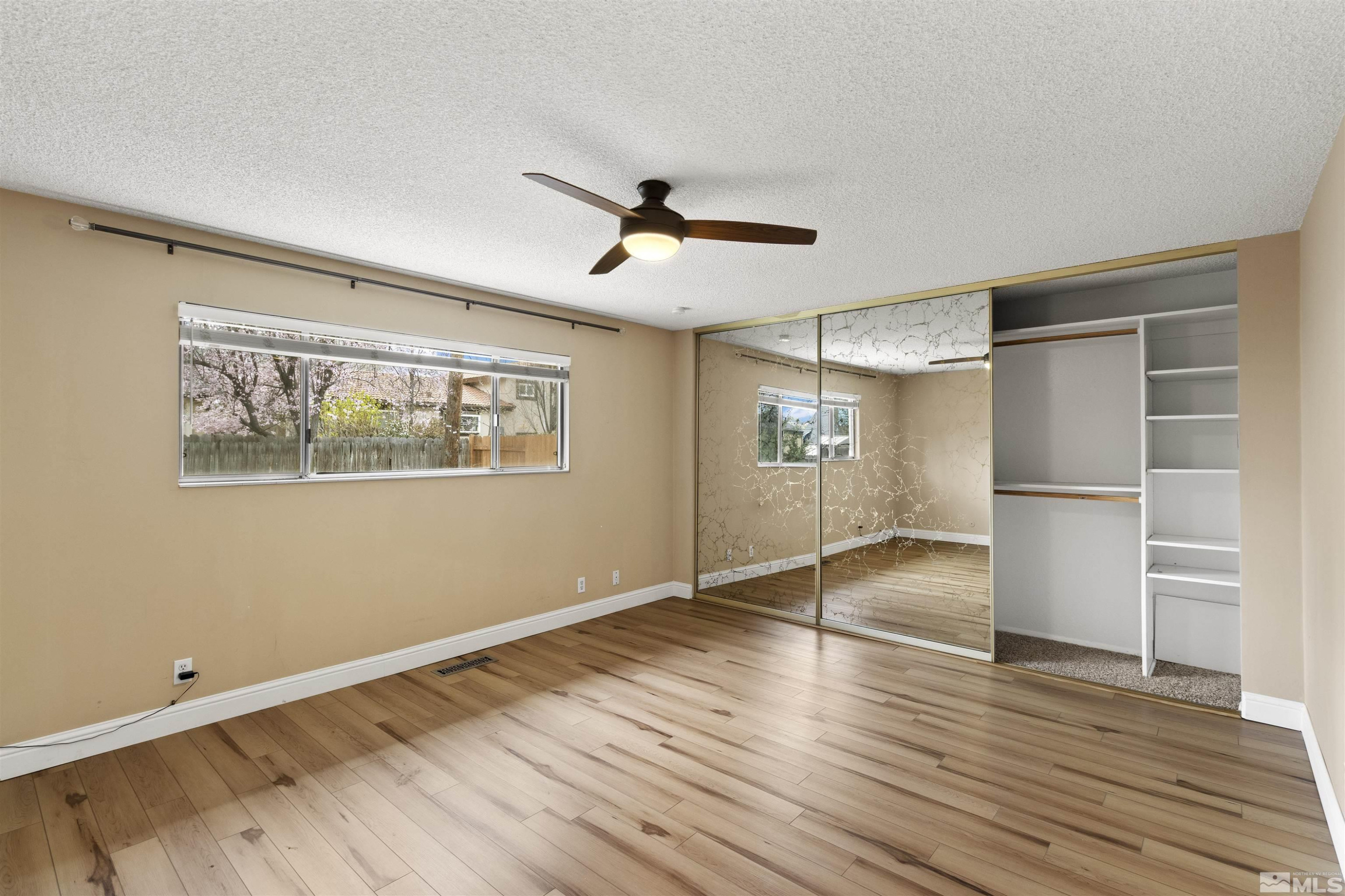 1430 Foster Drive Reno, NV 89509 - Photo 15 of 25 a view of empty room with wooden floor and fan